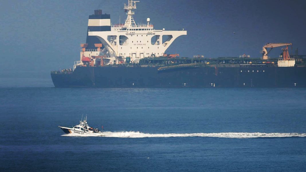 A Spanish Civil Guard boat sails past Iranian oil tanker