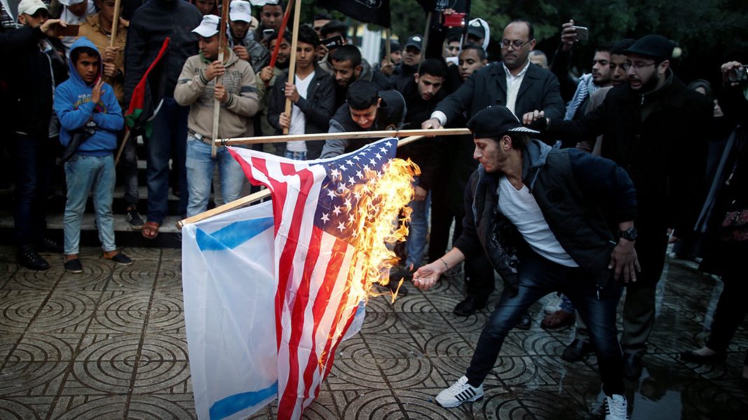 Palestinians burned an Israeli and a US flag during a protest in Gaza City.