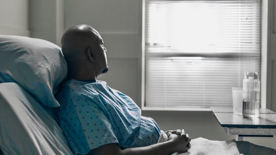 a hospital patient stares out window of room scaled 2