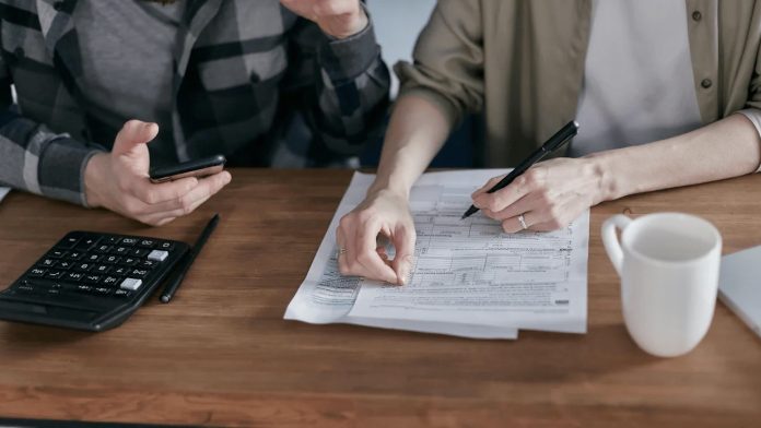 a married couple figuring out their tax forms together 4982605