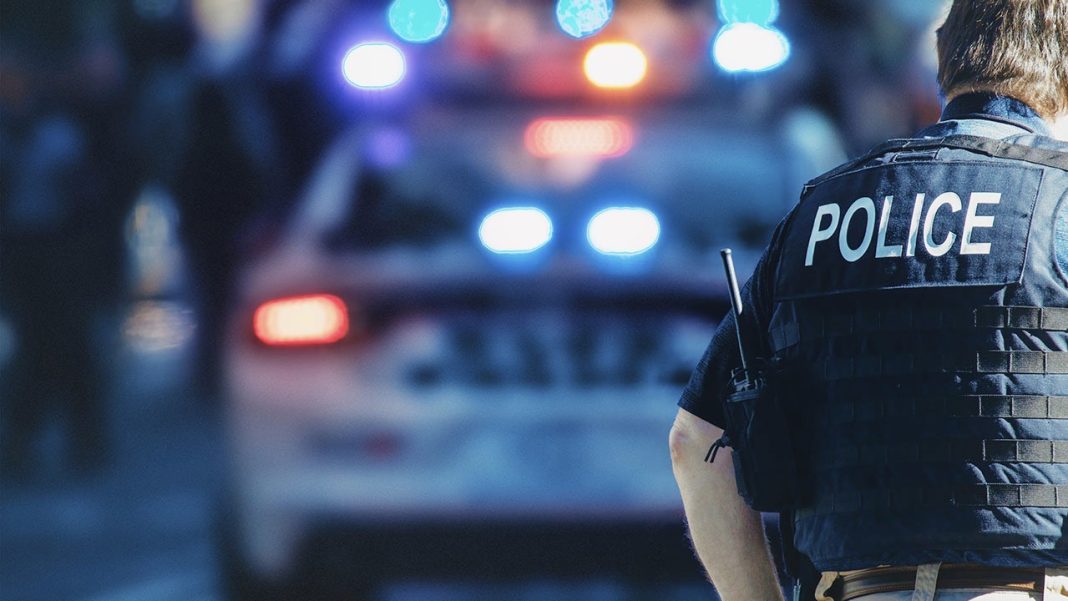 policeman with car in background 2
