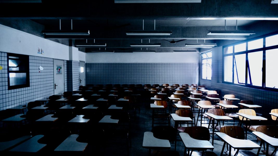 empty classroom illuminated by some shiny windows